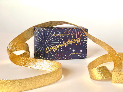Soap bar with 'Congratulations' text and gold ribbon on a white background