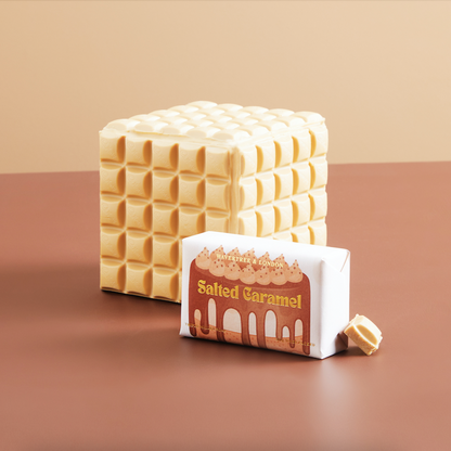 Stack of salted caramel candy bars with packaging on a brown background
