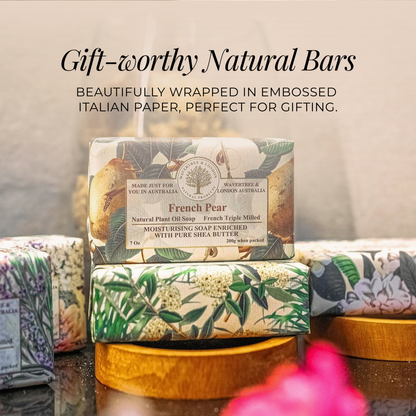 French Pear natural soap bar with embossed Italian paper packaging on a wooden stand.